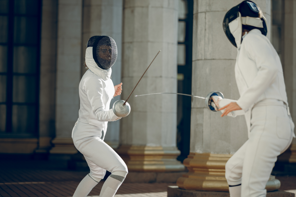 two people fencing in white suits, the blades are very thin and bendy two people fencing in white suits, the blades are very thin and bendy